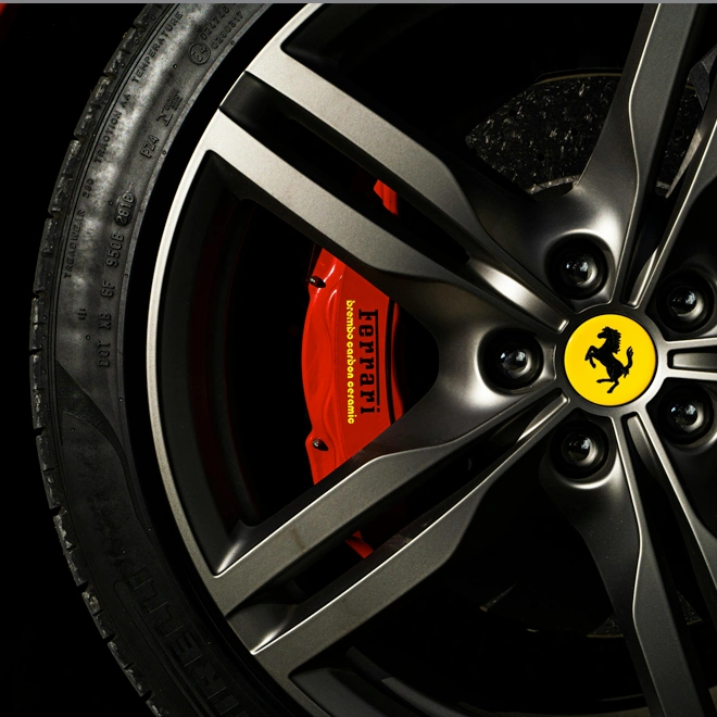Ferrari wheel with logo and red Brembo brake caliper