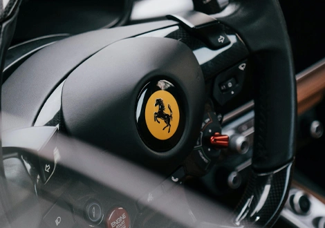 Ferrari steering wheel with prancing horse logo and carbon fiber details